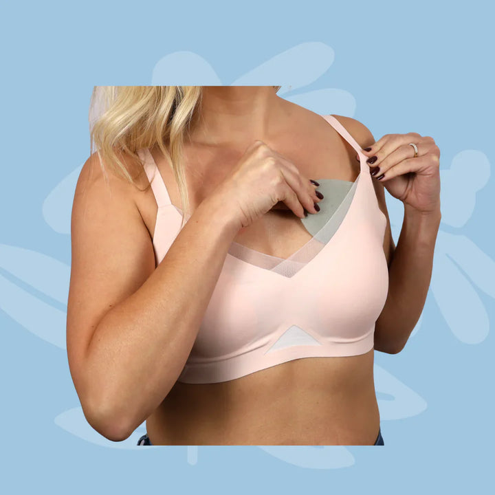Woman using Keep Me Cool by Issviva includes soft, reusable cooling bra inserts designed to soothe hot flushes and provide all-day comfort.